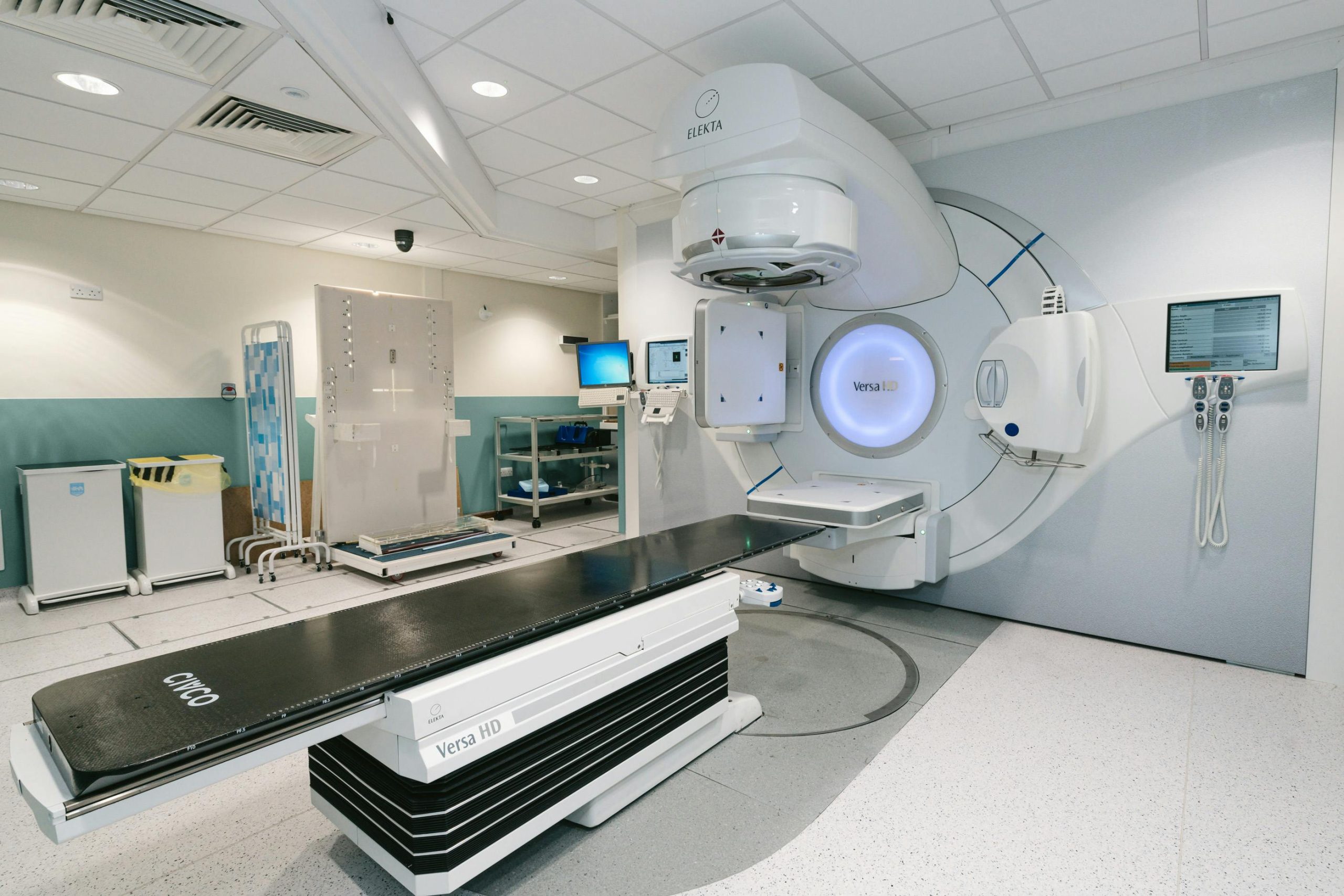 High-tech radiotherapy machine in a hospital's clinical setting for patient treatment.